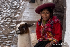 Woman in Traditional Dress with a Llama