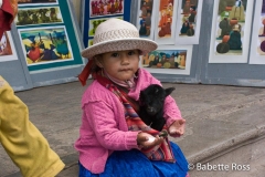 Small Child in Traditional Dress with a Baby Llama
