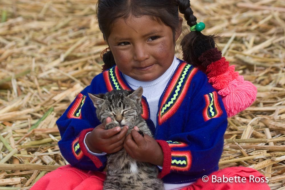 Uros Little Girl in Traditional Dress with a Kitten